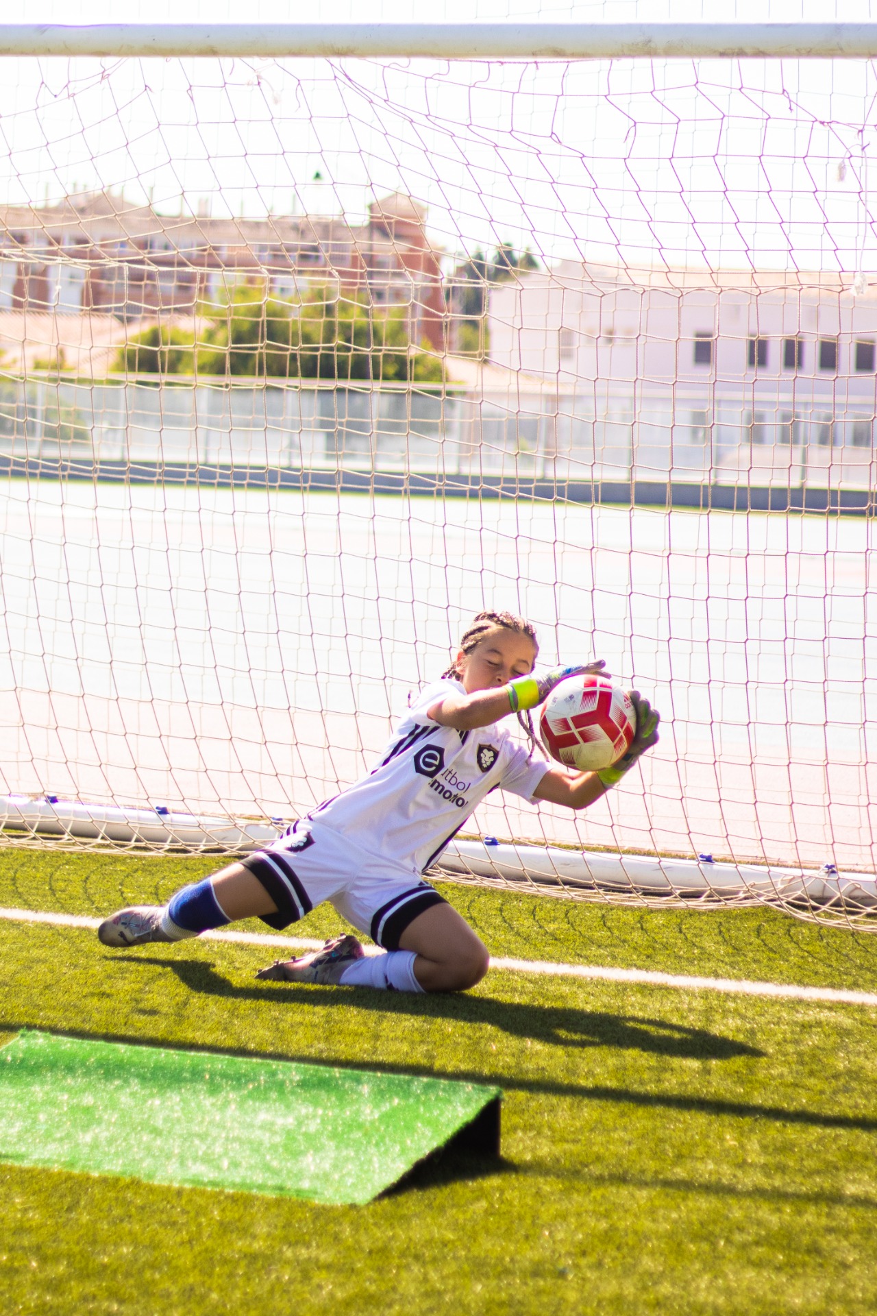 A young goalkeeper practising during a Premier Football training session.